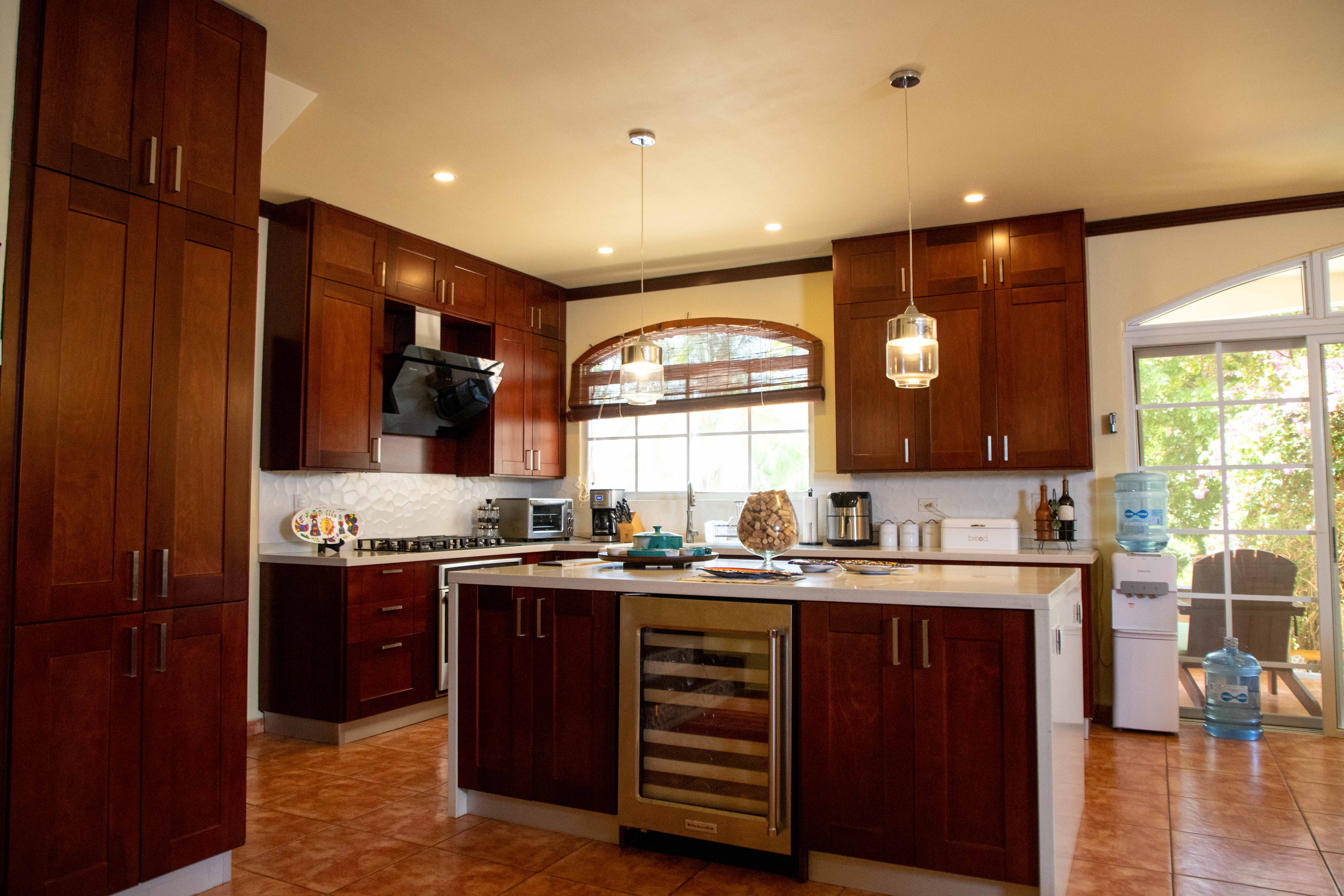 Kitchen with arched window and tropical garden view